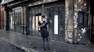 A person takes a picture outside a vandalised restaurant the morning after Paris riots over fuel taxes, December 2, 2018
