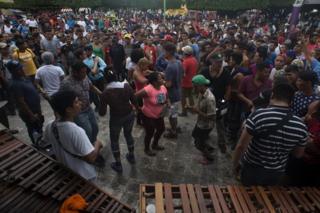 Migrants dance was local musicians play music in the central square of Ciudad de Hidalgo