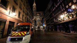 Rescue vehicles are parked near the Christmas market near the site of the deadly shooting in Strasbourg on 12 December 2018