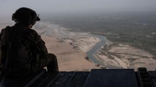 A US Army helicopter flies over Camp Shorab in Helmand Province, Afghanistan.