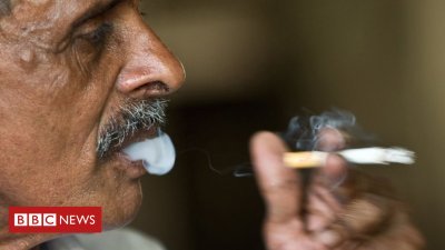 Hand Over-smoking helpline number on India cigarette packs